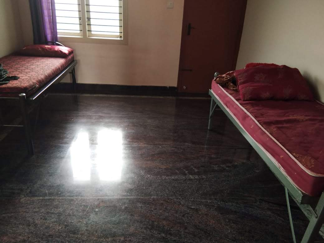 Single sharing room with cot, mattress and wardrobe